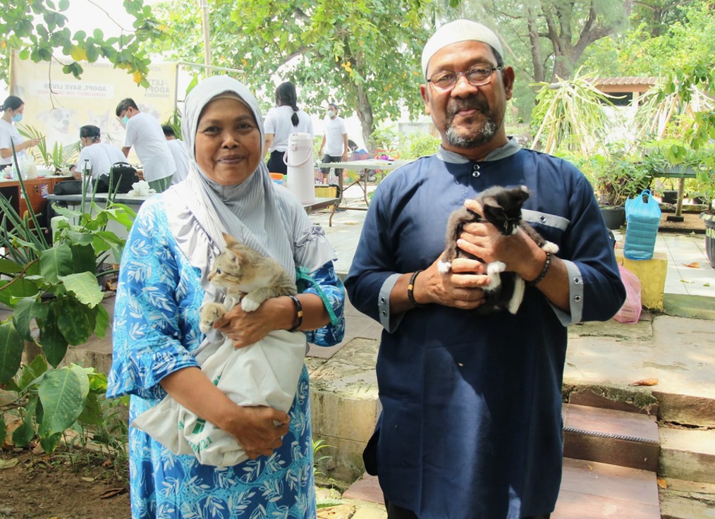 Community members holding rescued kittens